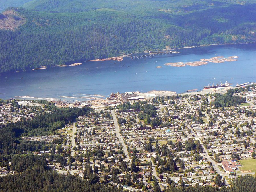 Aerial view of Port Alberni, B.C. showing the harbour, forested mountains, and residential neighbourhoods